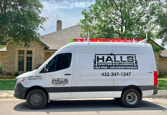 A friendly Halls Rooter & Plumbing service van parked at a customer’s residential home.